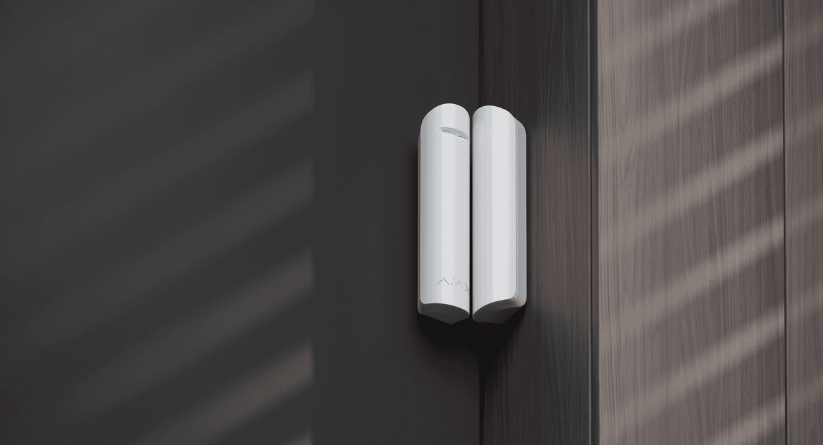 Ajax DoorProtect in white fitted to a door