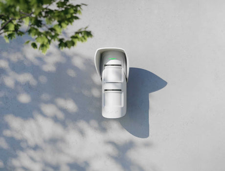 Ajax Hood for MotionProtect Outdoor shown in use